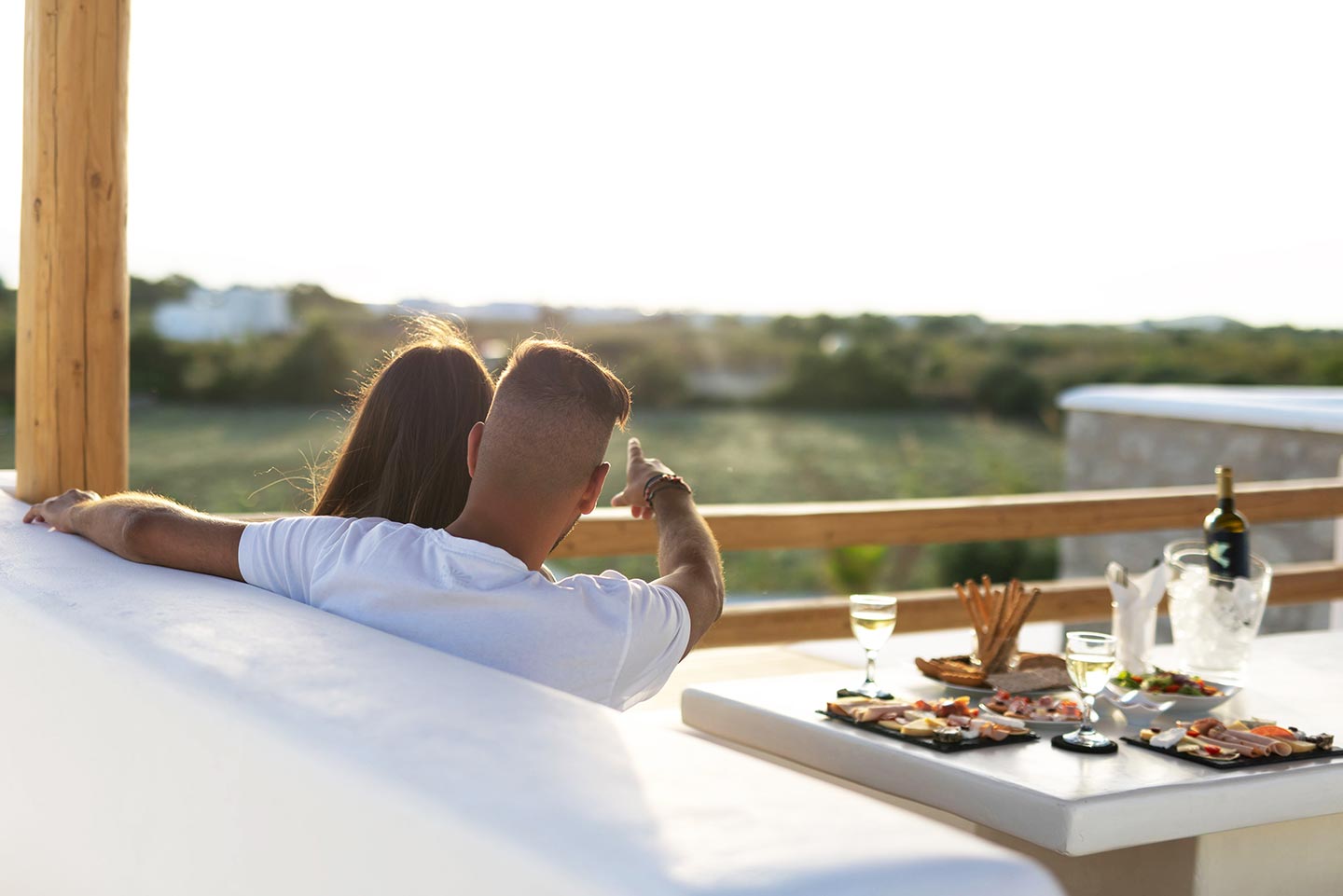 Romantic couple watching the sunset from the rooftop terrace in Naxos. Olives Seaside Villas, Plaka, Naxos