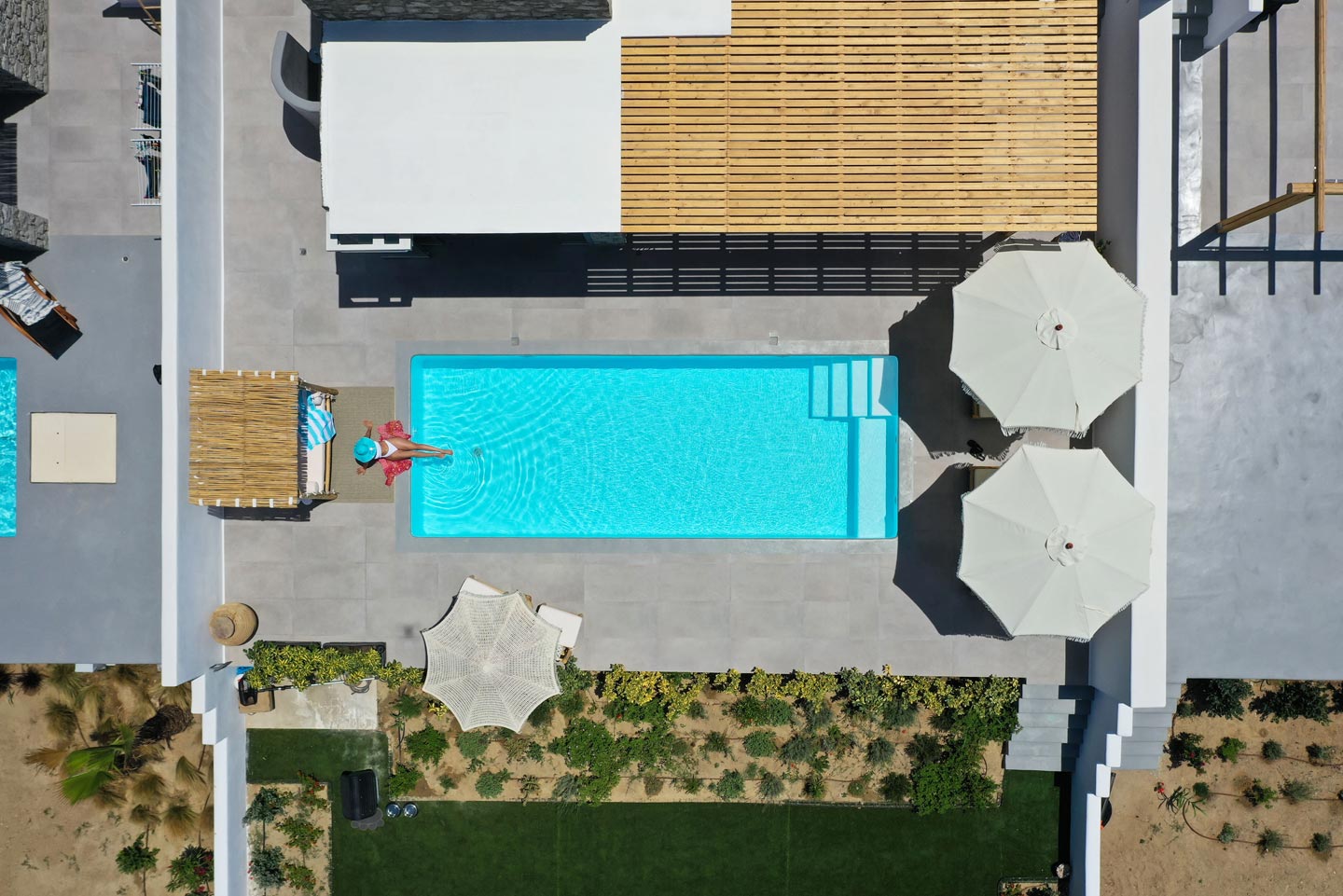 Aerial view of a villa in Naxos captured by a drone, showcasing the pool, yard, and main villa building. Olives Seaside Villas, Plaka, Naxos