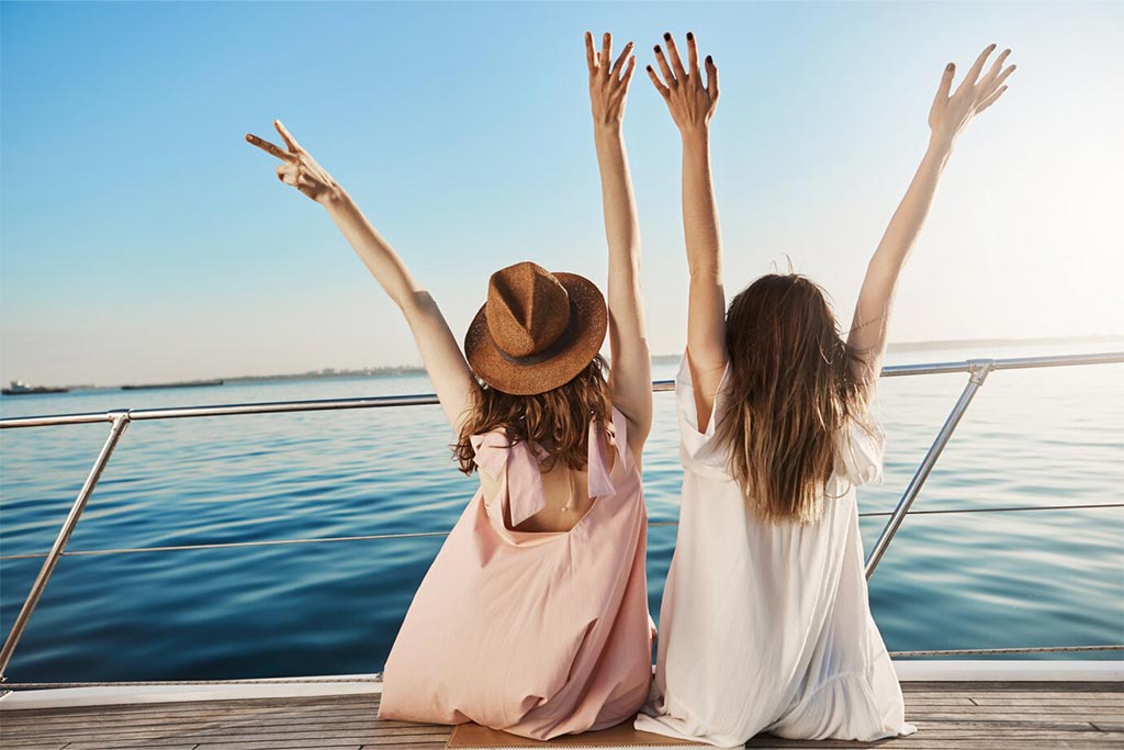 Two girls sailing on a boat, enjoying the sea breeze. Olives Seaside Villas, Plaka, Naxos